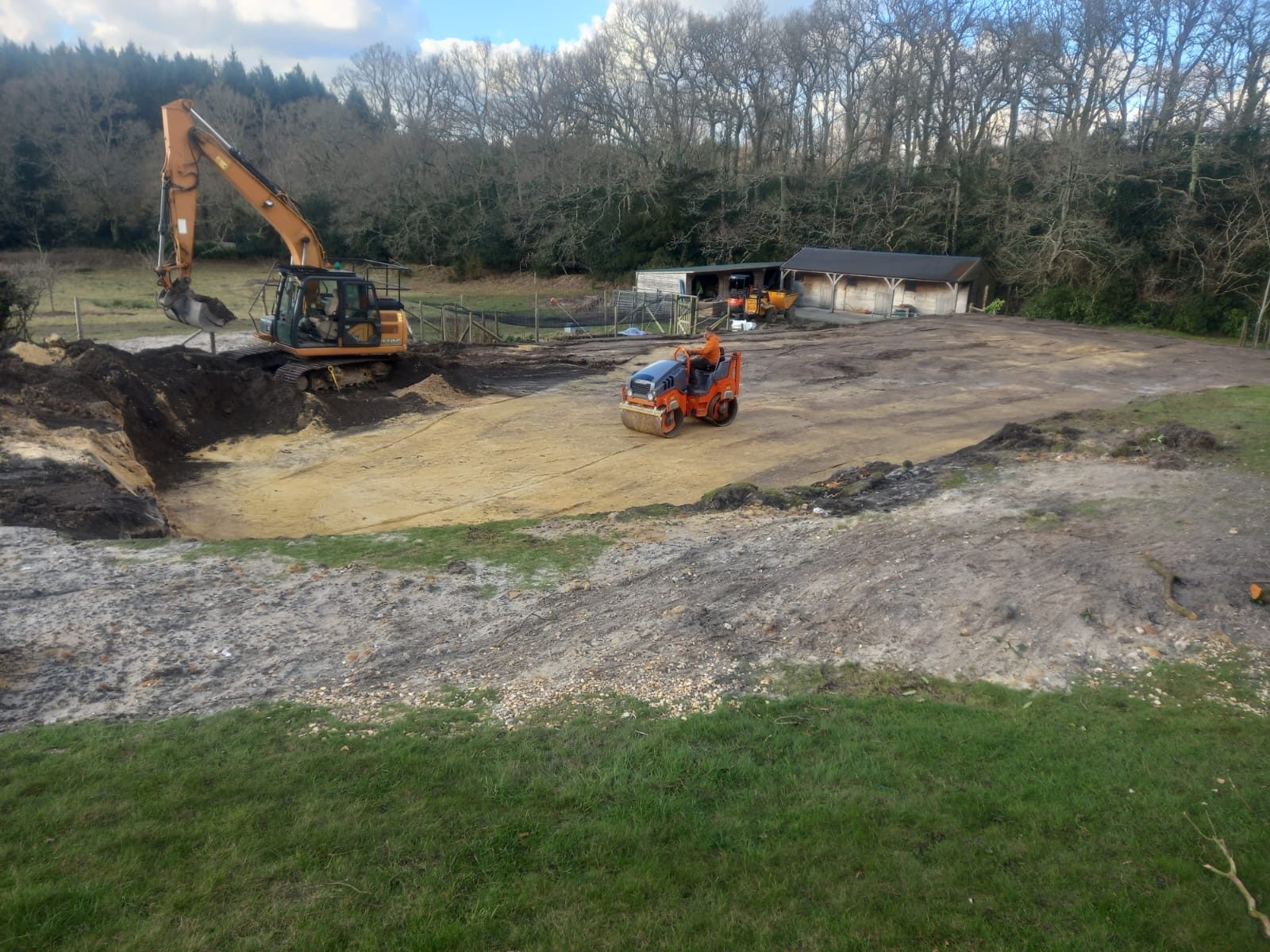 Excavator and roller on a Mustills groundworks project